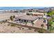 Aerial view of desert landscape with a home featuring a tile roof and back patio at 12720 Davis Wright Ct, Henderson, NV 89044