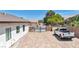 Spacious dirt backyard of home featuring block wall and an iron gate and truck parked on dirt at 12720 Davis Wright Ct, Henderson, NV 89044