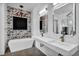 Beautiful bathroom with an elegant chandelier, stylish wall, double sink, and modern tub at 12720 Davis Wright Ct, Henderson, NV 89044