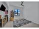 Bright bedroom featuring a ceiling fan, large window, and stylish rug at 12720 Davis Wright Ct, Henderson, NV 89044