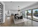 Open-concept dining area with a modern table, chairs, and access to an outdoor patio at 12720 Davis Wright Ct, Henderson, NV 89044