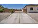 Long concrete driveway leading to an iron gate with rock landscaping at 12720 Davis Wright Ct, Henderson, NV 89044
