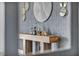 Inviting entryway table with decorative bottles, abstract art, and gold accents creating a stylish focal point at 12720 Davis Wright Ct, Henderson, NV 89044