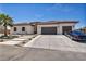 Charming single-story home featuring a tile roof, desert landscaping, and a spacious driveway at 12720 Davis Wright Ct, Henderson, NV 89044