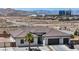 Striking single-story home featuring a three-car garage, desert landscaping, and modern architectural details at 12720 Davis Wright Ct, Henderson, NV 89044