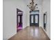 Elegant foyer with iron doors, a chandelier, and a wine room at 12720 Davis Wright Ct, Henderson, NV 89044
