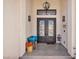Close-up of elegant entryway with decorative iron double doors and a covered porch at 12720 Davis Wright Ct, Henderson, NV 89044