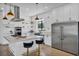Modern kitchen with stainless steel appliances and bright island with barstool seating and ample storage at 12720 Davis Wright Ct, Henderson, NV 89044