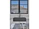 Modern matte black kitchen sink with a black faucet under a large window at 12720 Davis Wright Ct, Henderson, NV 89044