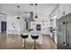 Modern kitchen with marble countertops, stainless steel appliances, and stylish pendant lighting at 12720 Davis Wright Ct, Henderson, NV 89044