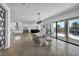 Bright open floorplan with large glass doors and stylish dining area leading to the kitchen at 12720 Davis Wright Ct, Henderson, NV 89044
