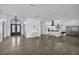 Bright open living area with a modern chandelier, fireplace, and access to the modern kitchen at 12720 Davis Wright Ct, Henderson, NV 89044