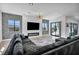 Stylish living room with a modern fireplace, large sofa and views from the sliding glass doors at 12720 Davis Wright Ct, Henderson, NV 89044