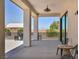 Inviting covered patio featuring stylish lighting, comfortable seating, and a view of the surrounding landscape at 12720 Davis Wright Ct, Henderson, NV 89044