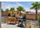 Outdoor patio featuring palm trees, wooden barrels, and a grill perfect for backyard entertainment and outdoor living at 12720 Davis Wright Ct, Henderson, NV 89044
