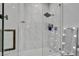Stunning walk-in shower boasts sleek glass enclosure, contemporary fixtures, and marble-look tiling for an upscale feel at 12720 Davis Wright Ct, Henderson, NV 89044