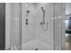 The elegant shower boasts marble tile, dual shower heads, and a modern glass enclosure at 12720 Davis Wright Ct, Henderson, NV 89044