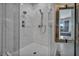 A luxurious shower with marble tile, dual shower heads, and glass enclosure at 12720 Davis Wright Ct, Henderson, NV 89044