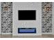 Statement wall featuring a modern fireplace, geometric patterns, and artistic wallpaper at 12720 Davis Wright Ct, Henderson, NV 89044