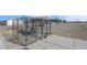 View of an expansive metal dog kennel surrounded by a large, gravel-filled yard at 1581 Cavalry St, Pahrump, NV 89048