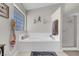 Bright bathroom with a separate shower and tub and a glass block window at 1581 Cavalry St, Pahrump, NV 89048