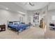 Bright bedroom with high ceilings, a ceiling fan, a workspace, and a comfortable bed with a blue comforter at 1581 Cavalry St, Pahrump, NV 89048