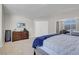 Well-lit carpeted bedroom with closet, dresser and wall-mounted television at 1581 Cavalry St, Pahrump, NV 89048