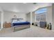 Spacious bedroom with large window, neutral carpet, and modern furnishings at 1581 Cavalry St, Pahrump, NV 89048