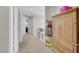 Hallway with carpet and natural light, offering a transition space between different rooms at 1581 Cavalry St, Pahrump, NV 89048