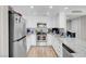 Updated kitchen with white cabinetry, stainless steel appliances, and granite countertops provides a modern touch at 1581 Cavalry St, Pahrump, NV 89048