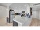 Bright kitchen features white cabinets, stainless appliances, and granite counters with an island counter and sink at 1581 Cavalry St, Pahrump, NV 89048