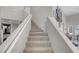 Carpeted staircase with white railings and walls, offering a clean and inviting pathway to the upper floor at 1581 Cavalry St, Pahrump, NV 89048