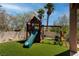 Backyard with a playhouse and swingset installed on artificial grass at 1790 Castro Hill Ave, Henderson, NV 89012