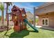 Backyard with a playhouse and slide installed on artificial grass at 1790 Castro Hill Ave, Henderson, NV 89012