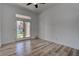 Bedroom featuring wood-look flooring, backyard access, and a view of the play structure at 1790 Castro Hill Ave, Henderson, NV 89012