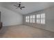 Large bedroom featuring carpeted flooring, ceiling fan, and shuttered windows at 1790 Castro Hill Ave, Henderson, NV 89012