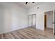 Minimalist bedroom design featuring light wood-look floors, closet, and bright natural light at 1790 Castro Hill Ave, Henderson, NV 89012