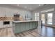 Bright kitchen features a large island, stainless appliances, and French doors at 1790 Castro Hill Ave, Henderson, NV 89012
