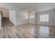 A bright living room with wood floors, staircase, and a double door entrance at 1790 Castro Hill Ave, Henderson, NV 89012