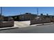 Modest home featuring a simple facade, concrete driveway, and a low block wall bordering the property at 1908 Palmer St, North Las Vegas, NV 89030
