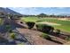 Scenic view of a lush golf course with manicured greens and sand traps, set against a backdrop of mountains at 2024 Bay Tree Dr, Las Vegas, NV 89134