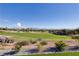 Expansive view of a well-maintained golf course with sand traps, set beneath a clear blue sky and distant mountains at 2024 Bay Tree Dr, Las Vegas, NV 89134