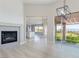 Bright living room boasts a modern fireplace, elegant light fixture, and a seamless transition to the outdoor area at 2024 Bay Tree Dr, Las Vegas, NV 89134