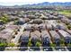Expansive aerial view of a neighborhood with houses, streets, and mountain backdrop at 2116 Via Firenze, Henderson, NV 89044