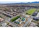 Community aerial showcasing the park and neighborhood with picturesque mountain views in the distance at 2116 Via Firenze, Henderson, NV 89044