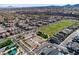 Aerial of community with a park, green field, and tennis courts offering recreation for residents at 2116 Via Firenze, Henderson, NV 89044
