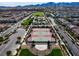 Aerial view of a community park with tennis courts and a playground at 2116 Via Firenze, Henderson, NV 89044
