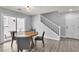 Bright dining area with sliding door access to patio and stairway to second level at 2116 Via Firenze, Henderson, NV 89044