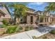 Charming two-story home with stone accents, landscaped front yard, and inviting curb appeal at 2116 Via Firenze, Henderson, NV 89044