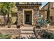 Inviting front entrance with stone columns, brick steps, and mature landscaping enhancing the home's appeal at 2116 Via Firenze, Henderson, NV 89044